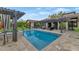 Beautiful pool area with lounge seating beneath a pergola and lush greenery around the pool deck at 6102 E Calle Del Norte --, Scottsdale, AZ 85251