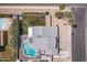 Aerial view of the backyard featuring a sparkling pool, lush lawn, and inviting patio space at 6237 W Altadena Ave, Glendale, AZ 85304