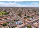 Aerial view of a neighborhood showcasing a property with pool, lawn, and proximity to nearby amenities at 6237 W Altadena Ave, Glendale, AZ 85304