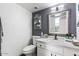 Neat bathroom featuring a single sink vanity, a decorative mirror, and nice wall decor at 6237 W Altadena Ave, Glendale, AZ 85304