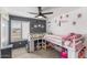 Shared ' bedroom features two beds, a ceiling fan, and closet doors at 6237 W Altadena Ave, Glendale, AZ 85304