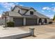 Home exterior featuring a three-car garage, well-kept lawn, and brick accents for added curb appeal at 6237 W Altadena Ave, Glendale, AZ 85304