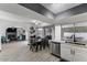 Bright kitchen featuring white cabinets, stainless steel appliances, a dining table, and an open layout at 6237 W Altadena Ave, Glendale, AZ 85304