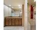 Spacious bathroom featuring double vanity with granite countertops and tile shower with red panel and multiple jets at 6252 E Aire Libre Ln, Scottsdale, AZ 85254