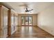 Bedroom boasting wood floors, ceiling fan, and access to outdoor patio at 6252 E Aire Libre Ln, Scottsdale, AZ 85254