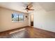 Light-filled bedroom with hardwood floors, ceiling fan, and a view to the outside at 6252 E Aire Libre Ln, Scottsdale, AZ 85254