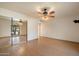 Bedroom features tile flooring, ceiling fan, and mirrored closet at 6252 E Aire Libre Ln, Scottsdale, AZ 85254
