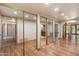 Spacious bedroom features wood floors, mirrored closets, and ensuite bath access at 6252 E Aire Libre Ln, Scottsdale, AZ 85254