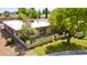 Single-story home boasts a clean white exterior, complemented by a well-manicured lawn and mature trees at 6252 E Aire Libre Ln, Scottsdale, AZ 85254