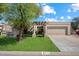 Inviting single-story home featuring a well-manicured lawn and charming desert landscaping at 6252 E Aire Libre Ln, Scottsdale, AZ 85254