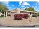 Charming single-story home featuring a low-maintenance desert landscape with vibrant flowering bushes in the front yard at 6252 E Aire Libre Ln, Scottsdale, AZ 85254