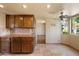 Kitchen view with plenty of wood cabinets, tile floors, and views through to a breakfast nook at 6252 E Aire Libre Ln, Scottsdale, AZ 85254
