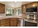 This home has an eat-in kitchen with wood cabinets, tile backsplash and stainless appliances at 6252 E Aire Libre Ln, Scottsdale, AZ 85254