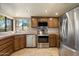 Well-lit kitchen featuring tile countertops, stainless steel appliances, and a view to the exterior at 6252 E Aire Libre Ln, Scottsdale, AZ 85254