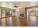 Spacious living room featuring a stone fireplace, ceiling fan and beautiful hardwood floors at 6252 E Aire Libre Ln, Scottsdale, AZ 85254