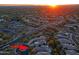 Scenic aerial view of a residential community highlighting the neighborhood layout at sunset at 6936 E Whispering Mesquite Trl, Scottsdale, AZ 85266