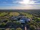 Expansive aerial view of the community, showcasing its meticulously maintained golf course and the scenic desert landscape at 6936 E Whispering Mesquite Trl, Scottsdale, AZ 85266