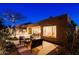 Backyard patio featuring outdoor kitchen, dining and seating areas, and lush desert landscaping at 6936 E Whispering Mesquite Trl, Scottsdale, AZ 85266