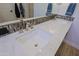 A view of a luxurious double vanity with marble counters and modern fixtures in the main bathroom at 6936 E Whispering Mesquite Trl, Scottsdale, AZ 85266