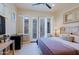 Inviting bedroom featuring a cozy bed, French doors to the outside, and a mini fridge, perfect for relaxation at 6936 E Whispering Mesquite Trl, Scottsdale, AZ 85266