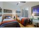 Bright bedroom featuring two twin beds, stylish decor, and a ceiling fan, perfect for a cozy and inviting space at 6936 E Whispering Mesquite Trl, Scottsdale, AZ 85266