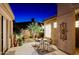 Picturesque courtyard with tile flooring and desert landscaping, enhanced by soft lighting at 6936 E Whispering Mesquite Trl, Scottsdale, AZ 85266