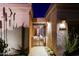 Welcoming entrance to the home, framed by desert plants and featuring a gated courtyard at 6936 E Whispering Mesquite Trl, Scottsdale, AZ 85266