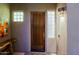 Inviting front entrance featuring a wood door with glass sidelights and decorative touches at 6936 E Whispering Mesquite Trl, Scottsdale, AZ 85266