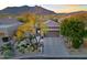Stunning home exterior with desert landscaping and mountain views in the background at 6936 E Whispering Mesquite Trl, Scottsdale, AZ 85266
