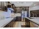 Stylish kitchen with dark cabinetry, stainless steel appliances, and a spacious island with white countertops at 6936 E Whispering Mesquite Trl, Scottsdale, AZ 85266