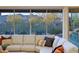 Comfortable living room featuring plush sectional sofa and scenic views of the backyard and mountains at 6936 E Whispering Mesquite Trl, Scottsdale, AZ 85266