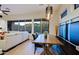 Open concept living room with dining area, patio access, and desert views at 6936 E Whispering Mesquite Trl, Scottsdale, AZ 85266
