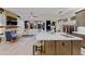 Inviting living space with fireplace, kitchen island, bar stool seating, and lots of natural light from the backyard at 6936 E Whispering Mesquite Trl, Scottsdale, AZ 85266