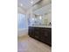 The main bathroom offers a soaking tub, a modern double vanity, and wood-style flooring at 6936 E Whispering Mesquite Trl, Scottsdale, AZ 85266