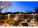 Inviting outdoor space featuring comfortable seating, a decorative metal fence, and desert landscaping at 6936 E Whispering Mesquite Trl, Scottsdale, AZ 85266