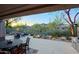 Outdoor patio area with furniture, landscaping, desert plants and trees providing backyard privacy at 6936 E Whispering Mesquite Trl, Scottsdale, AZ 85266
