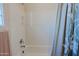 Clean shower and tub combination featuring a shower curtain, shower caddy and shower head at 6936 E Whispering Mesquite Trl, Scottsdale, AZ 85266
