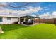 This backyard has a well-kept lawn with a covered hot tub and an additional seating area at 806 W El Alba Way, Chandler, AZ 85225