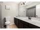 Bathroom featuring a toilet, dark vanity, and an above the counter rectangular sink at 806 W El Alba Way, Chandler, AZ 85225