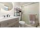Well-lit bathroom with a round mirror, sleek vanity, and a glass-enclosed shower at 806 W El Alba Way, Chandler, AZ 85225