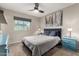 Comfortable bedroom with a ceiling fan, window view, and stylish decor at 806 W El Alba Way, Chandler, AZ 85225