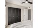 Bedroom with a full sized closet, ceiling fan, and a view of the bathroom at 806 W El Alba Way, Chandler, AZ 85225