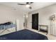 Bedroom with a ceiling fan, a clothes rack, and a view of a bathroom at 806 W El Alba Way, Chandler, AZ 85225