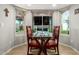 The dining room has large windows with a modern table set and tile floors at 806 W El Alba Way, Chandler, AZ 85225