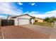 View of long driveway leading to a two-car garage, complimented by a privacy fence at 806 W El Alba Way, Chandler, AZ 85225