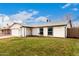 Well-maintained single-story home featuring green lawn, an attached garage and black trimmed windows at 806 W El Alba Way, Chandler, AZ 85225