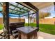 View of covered hot tub, plus a storage shed in well-maintained, grassy backyard at 806 W El Alba Way, Chandler, AZ 85225