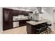 Well-equipped kitchen with dark wood cabinetry, stainless steel appliances, and granite countertops at 806 W El Alba Way, Chandler, AZ 85225