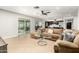 Open-concept living room flows into the kitchen with tile floors, glass doors to the backyard at 806 W El Alba Way, Chandler, AZ 85225