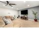 Cozy living room featuring a plush sectional sofa and entertainment center with large screen TV at 806 W El Alba Way, Chandler, AZ 85225